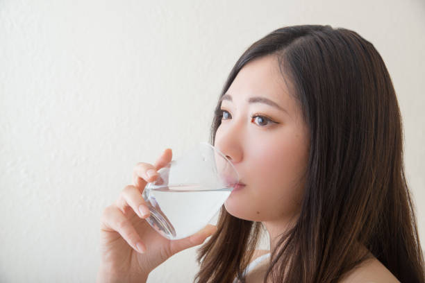 istock young asia women drinking water 1041977268
