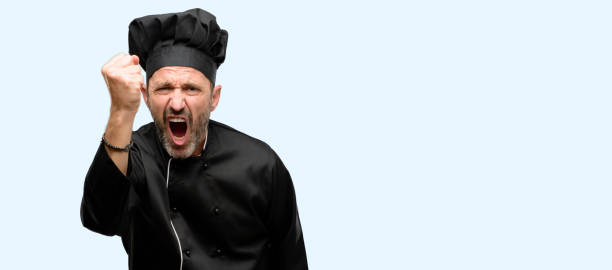 istock Senior cook man, wearing chef hat irritated and angry expressing negative emotion, annoyed with someone 1041978478