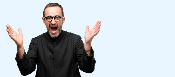 istock Priest religion man happy and surprised cheering expressing wow gesture 1041978534