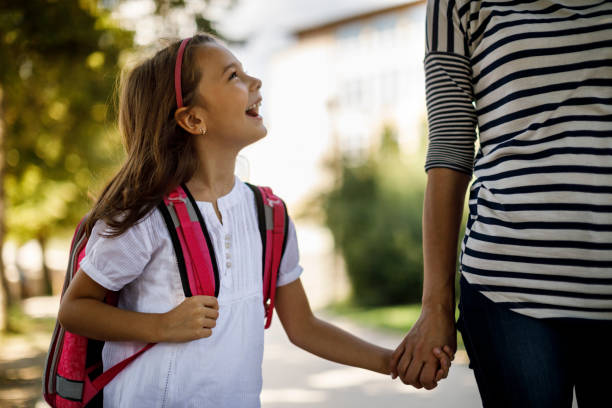 istock Cute cheerful schoolgirl going home 1041986526