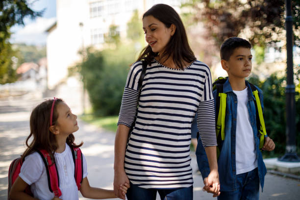 istock Mother and kids going home from school 1041987230