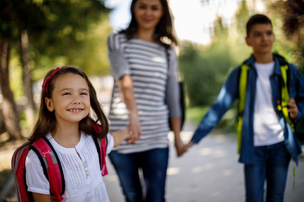 istock Mother and kids going home from school 1041987358