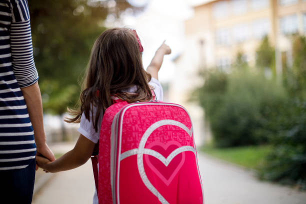 istock Mother taking her daughter to school 1041987594