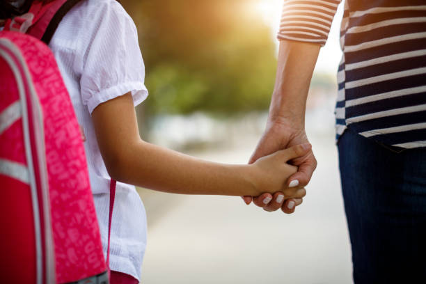 Mother and daughter holding hands Mother and daughter holding hands family holding hands stock pictures, royalty-free photos & images