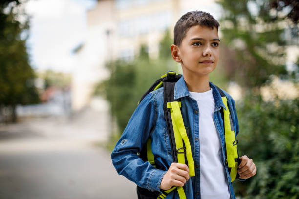 istock Teenage boy with school bag going home from school 1041987994