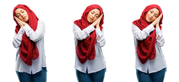 Arab woman wearing hijab tired and bored, tired because of a long day overworking isolated over white background