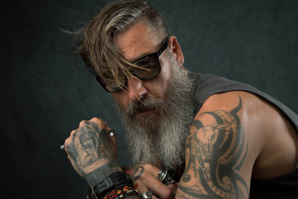 Portrait of a cool biker with sunglasses Portrait of a cool biker with sunglasses shoulder tattoo designs for men stock pictures, royalty-free photos & images