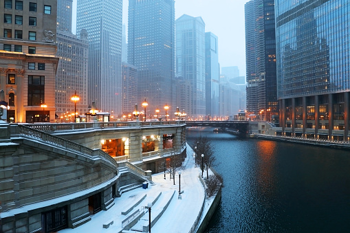 Beautiful Chicago downtown cityscape twilight winter view during snowfall. Illinois, Midwest USA.