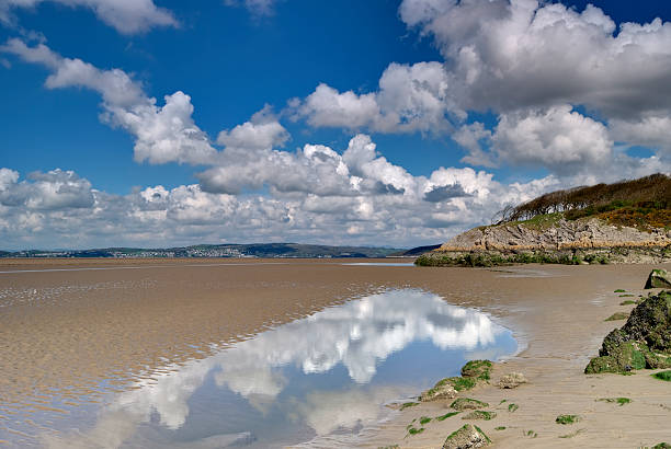 The low tide at Silverdale with the sky reflecting on water Sand at low tide in the Morecambe Bay estuary at low tide morecombe bay photos stock pictures, royalty-free photos & images