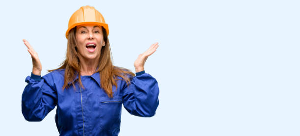 istock Engineer construction worker woman happy and surprised cheering expressing wow gesture 1042010782