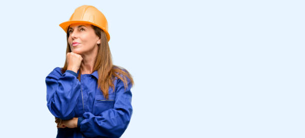 istock Engineer construction worker woman thinking and looking up expressing doubt and wonder 1042010836