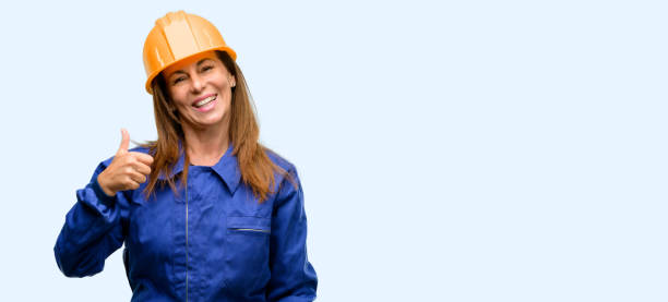 istock Engineer construction worker woman smiling broadly showing thumbs up gesture to camera, expression of like and approval 1042011190