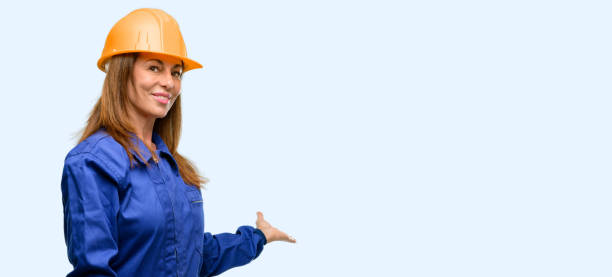 istock Engineer construction worker woman confident and happy with a big natural smile inviting to enter 1042011346