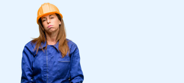 istock Engineer construction worker woman with sleepy expression, being overworked and tired 1042011518