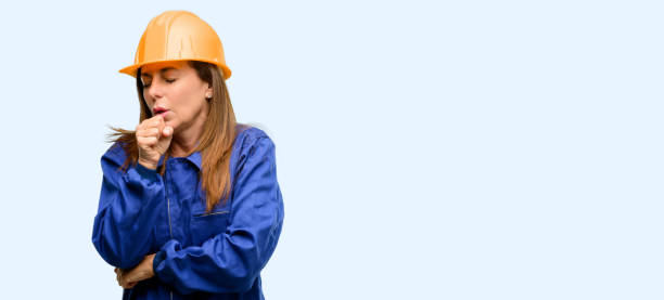 istock Engineer construction worker woman sick and coughing, suffering asthma or bronchitis, medicine concept 1042011582