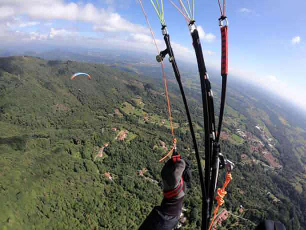 istock flying through the clouds in paraglide 1042011844