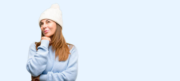 istock Middle age woman wearing wool winter cap thinking and looking up expressing doubt and wonder 1042012052