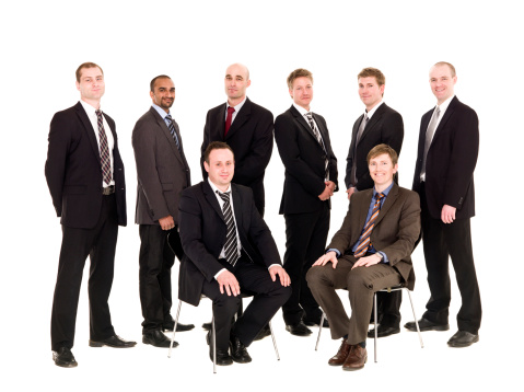 Portrait of multiethnic businesspeople smiling while standing in a row at office