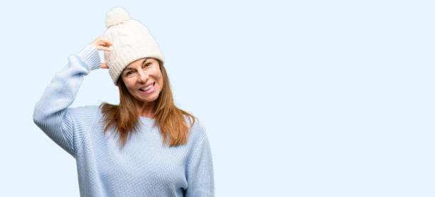 istock Middle age woman wearing wool winter cap doubt expression, confuse and wonder concept, uncertain future 1042012186