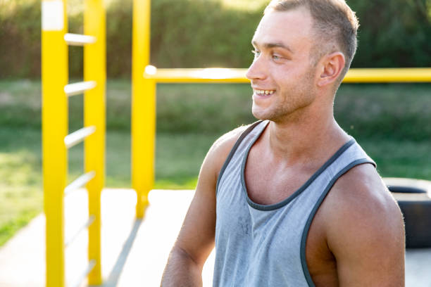 istock Smiling Young Man in Exercising Park 1042013046