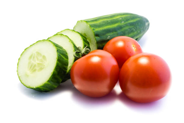 istock Cucumbers and tomatoes isolated on white background 1042013338