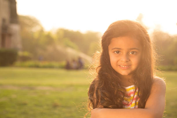 Child girl in the meadow, forest, walking and having fun time at the sunny summer day, breathing freshness. Soft blurred sunlight. Forest after rain with fresh air. Enjoying Life, travel, vacations