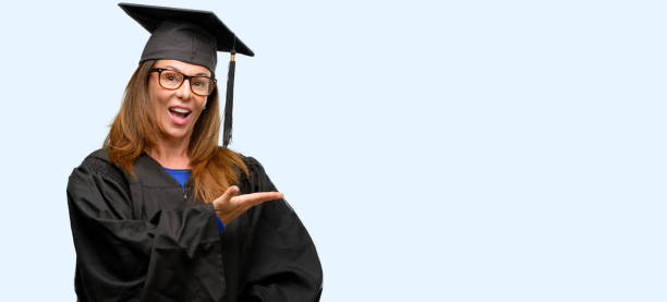 istock Senior graduate student woman holding something in empty hand 1042013738