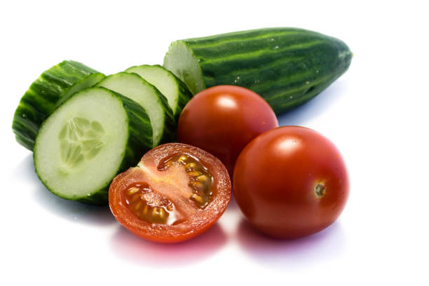 Cucumbers and tomatoes isolated on white background