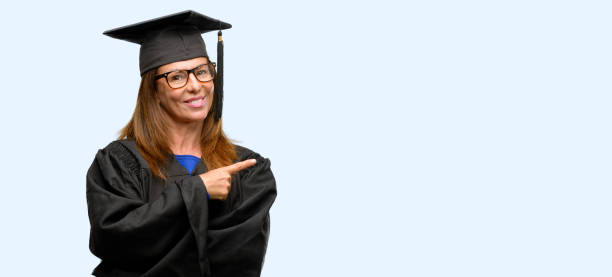 istock Senior graduate student woman pointing away side with finger 1042016214
