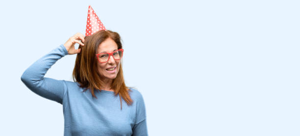 istock Middle age woman celebrates birthday doubt expression, confuse and wonder concept, uncertain future 1042016460
