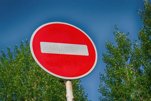 istock Road sign Entry prohibited on the background of tree crowns 1042017650
