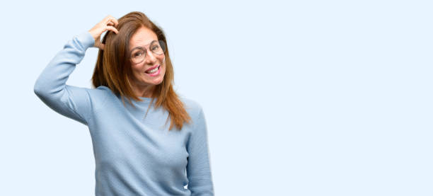 Middle age woman wearing wool sweater and cool glasses doubt expression, confuse and wonder concept, uncertain future