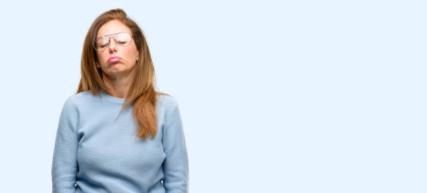 istock Middle age woman wearing wool sweater and cool glasses with sleepy expression, being overworked and tired 1042018004