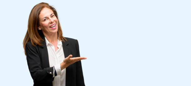 istock Middle age woman wearing jacket holding something in empty hand 1042018052