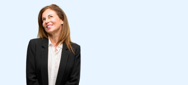 Middle age woman wearing jacket thinking and looking up expressing doubt and wonder