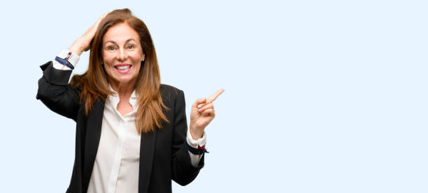 istock Middle age woman wearing jacket pointing away side with finger 1042018180