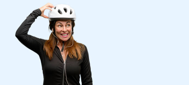 istock Middle age cyclist woman using earphones doubt expression, confuse and wonder concept, uncertain future 1042020658