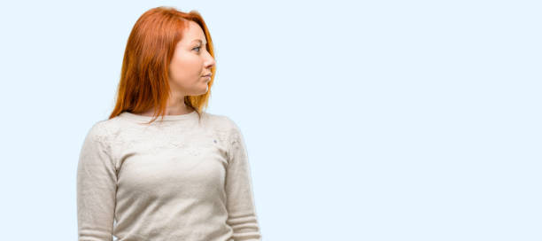 istock Beautiful young redhead woman side view portrait 1042020806