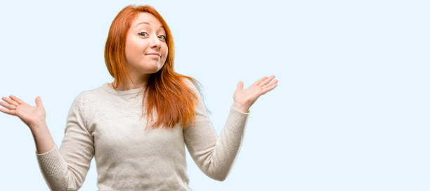 istock Beautiful young redhead woman doubt expression, confuse and wonder concept, uncertain future 1042020856