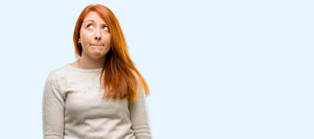 istock Beautiful young redhead woman doubt expression, confuse and wonder concept, uncertain future 1042020864