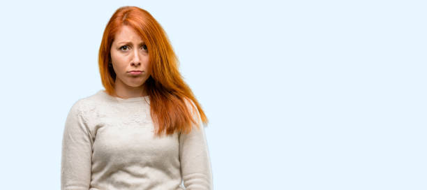 istock Beautiful young redhead woman with sad and upset expression, unhappy 1042020922