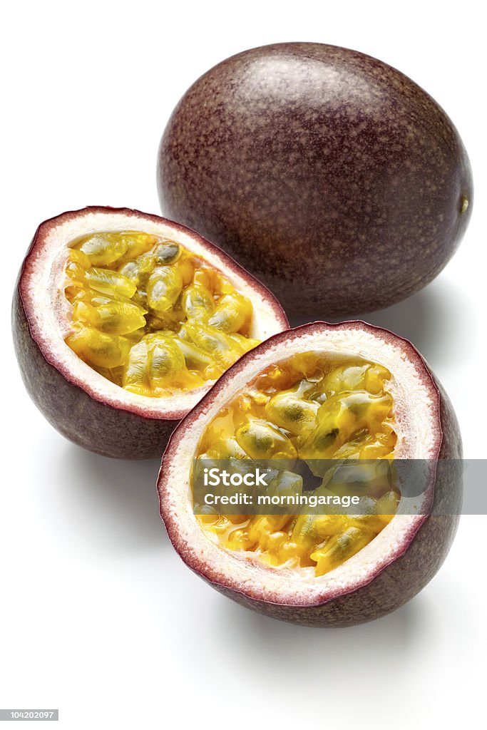 Two passion fruits, one cut in half, on a white background passion fruit　isolated on white Passion Fruit Stock Photo