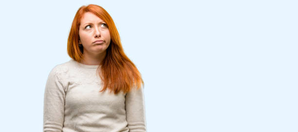 istock Beautiful young redhead woman doubt expression, confuse and wonder concept, uncertain future 1042021002