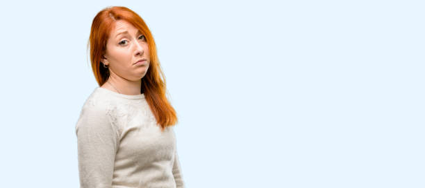 istock Beautiful young redhead woman having skeptical and dissatisfied look expressing Distrust, skepticism and doubt 1042021192