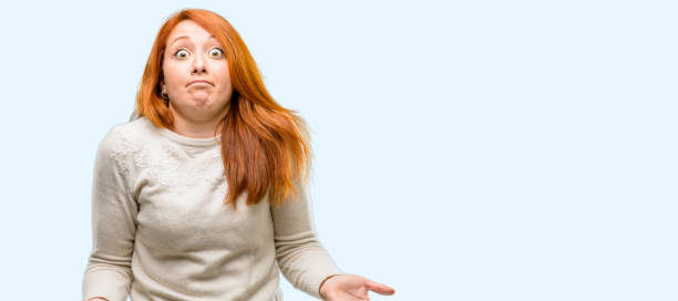istock Beautiful young redhead woman doubt expression, confuse and wonder concept, uncertain future 1042021482