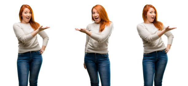 istock Young Beautiful redhead woman holding something in empty hand 1042021602