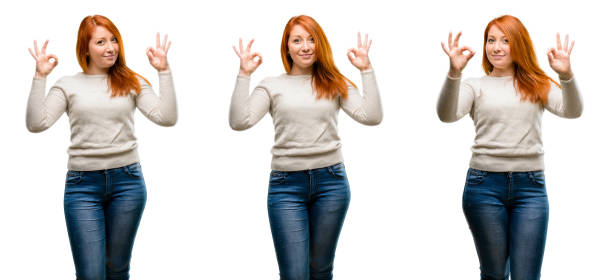 istock Young Beautiful redhead woman doing ok sign gesture with both hands expressing meditation and relaxation 1042021680