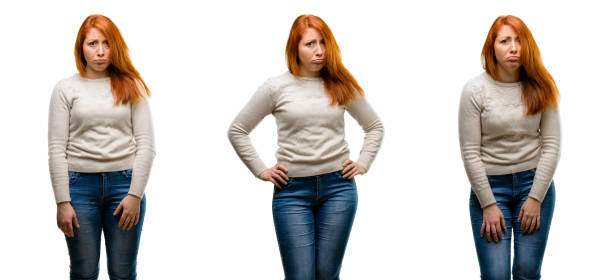 istock Young Beautiful redhead woman with sad and upset expression, unhappy 1042021736