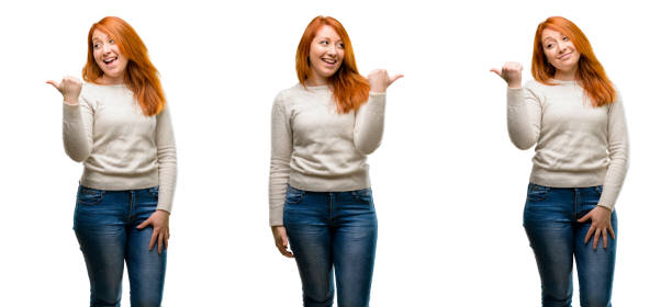 istock Young Beautiful redhead woman pointing away side with finger 1042021752