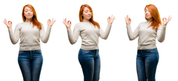 istock Young Beautiful redhead woman doing ok sign gesture with both hands expressing meditation and relaxation 1042021796